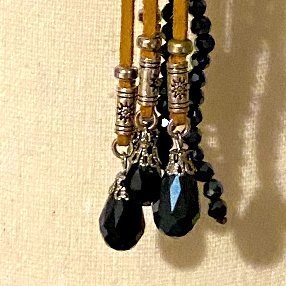 Necklace with royal  blue beads, that sparkle intertwined with tan suede.